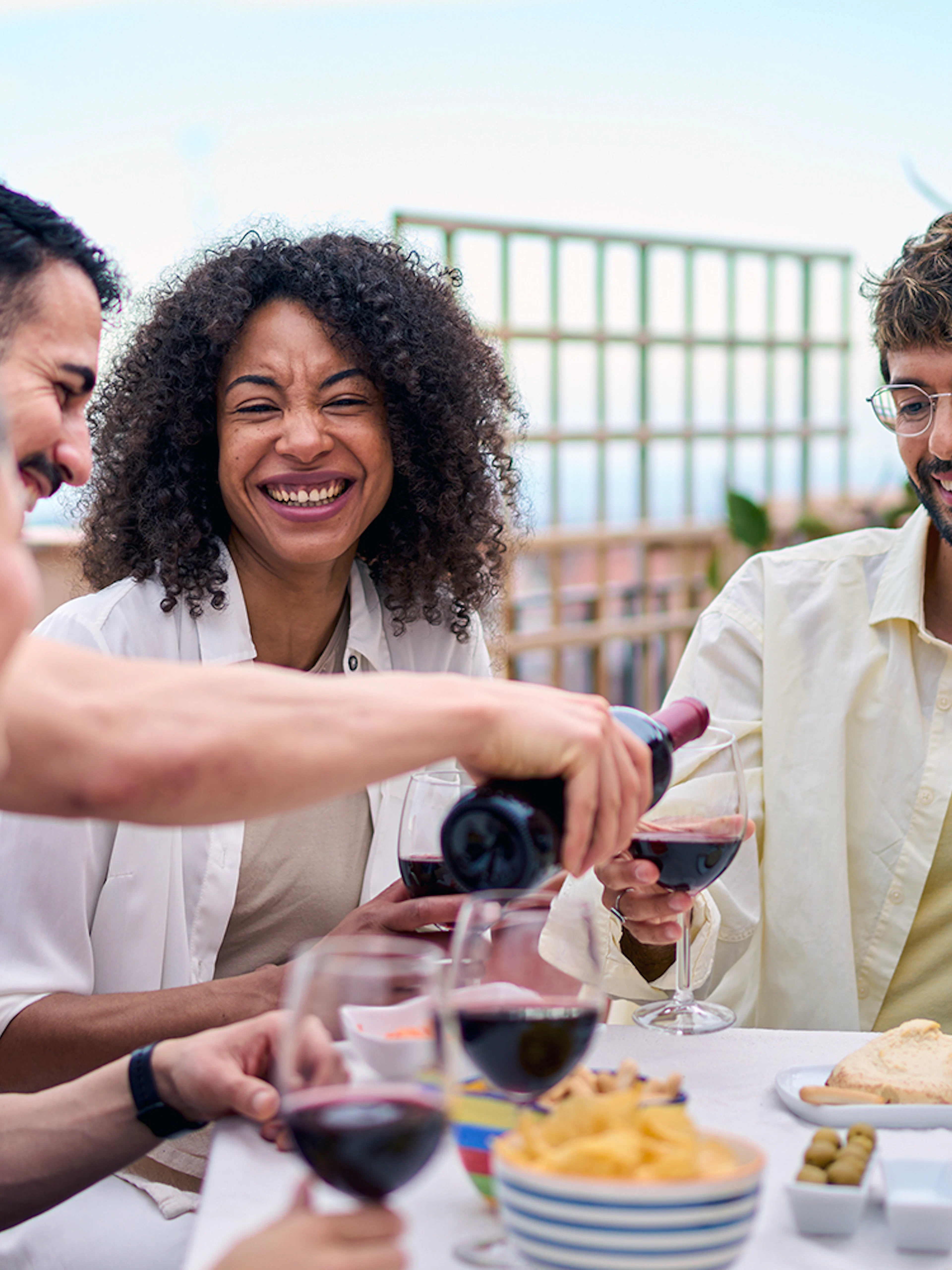 People enjoying lunch with wine on a terrace in Montserrat.