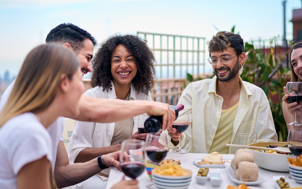 People enjoying lunch with wine on a terrace in Montserrat.