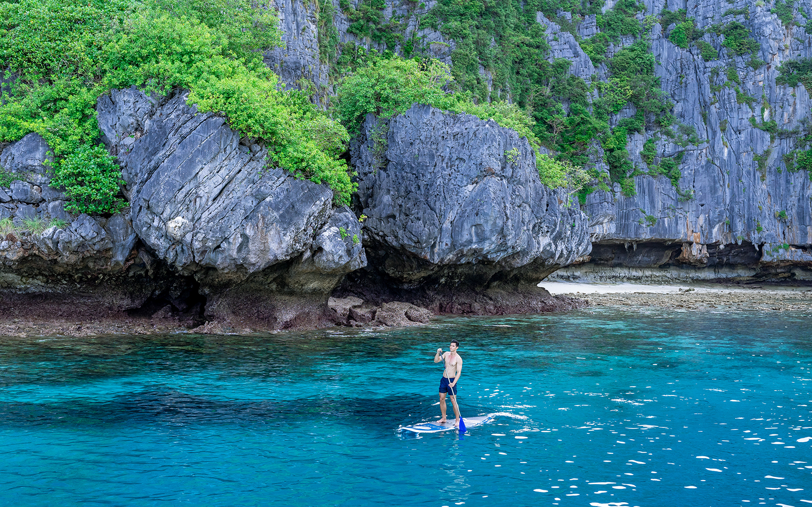 A man on a paddleboat - Phi Phi Islands