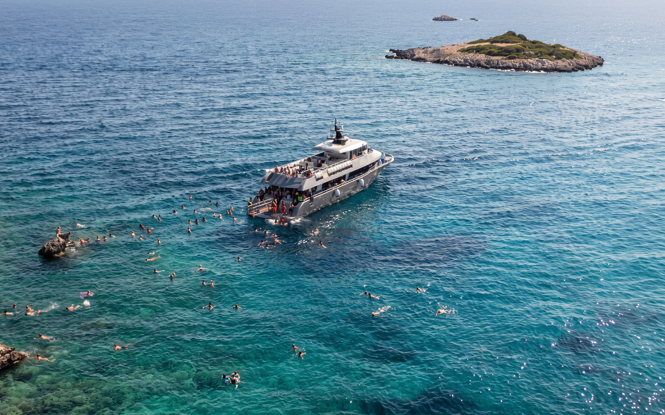 Cruise ship near Symi Island with swimmers in St. George Bay, Rhodes.