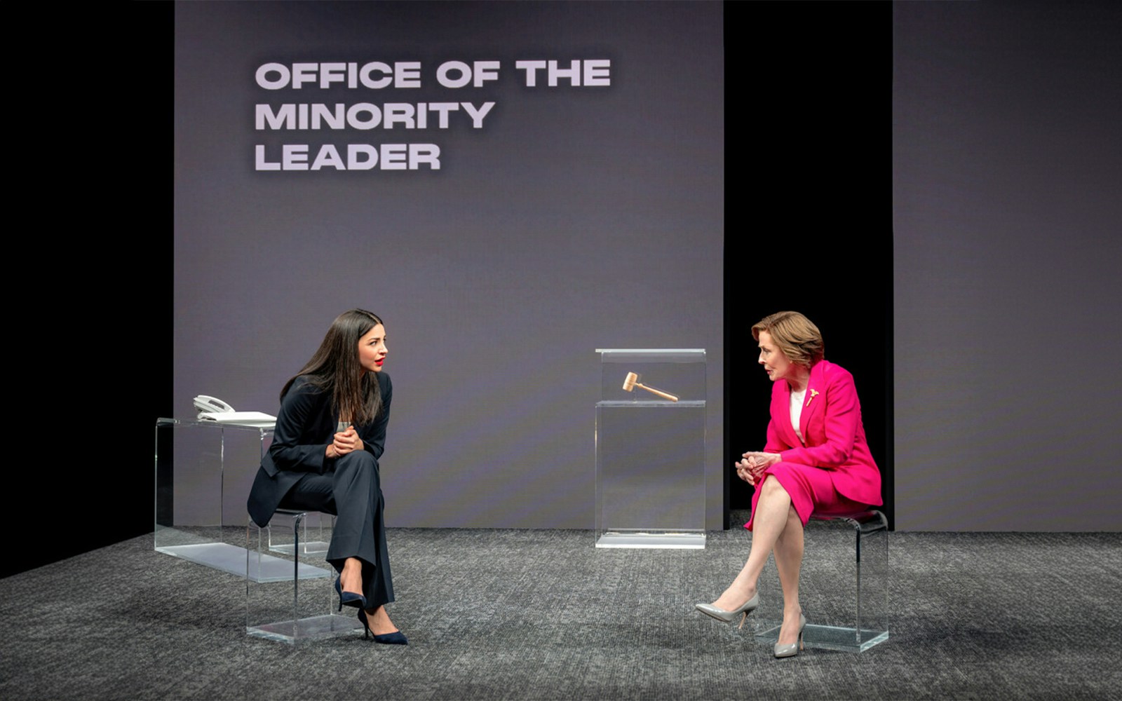 Two actors in a play set in the Office of the Minority Leader, engaged in a conversation.