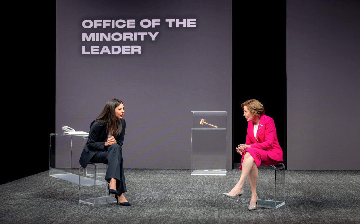 Two actors in a play set in the Office of the Minority Leader, engaged in a conversation.
