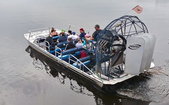 Airboat with passengers on a water safari near Kennedy Space Center.