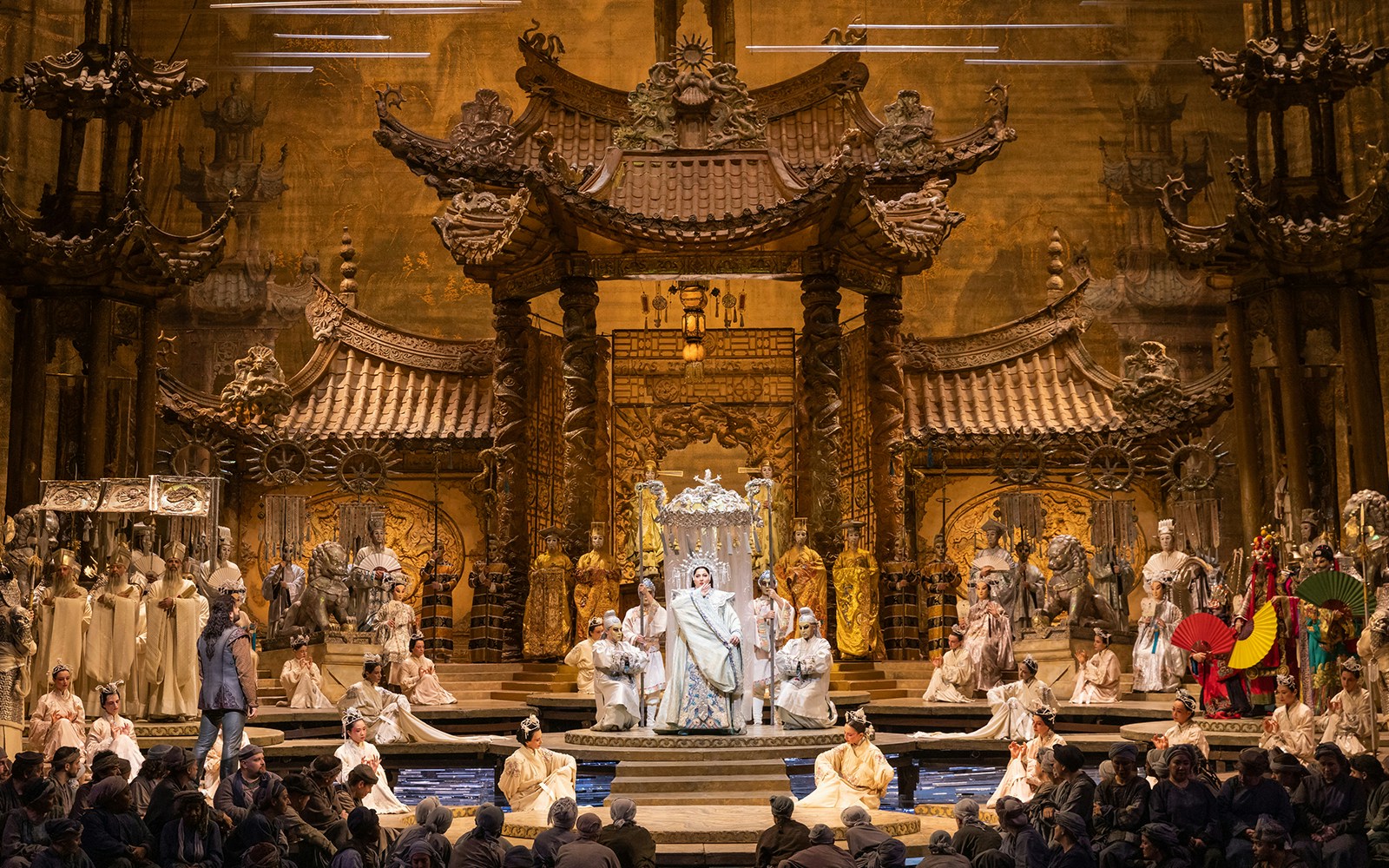 Opera performance of Turandot with elaborate set and costumed cast on stage.