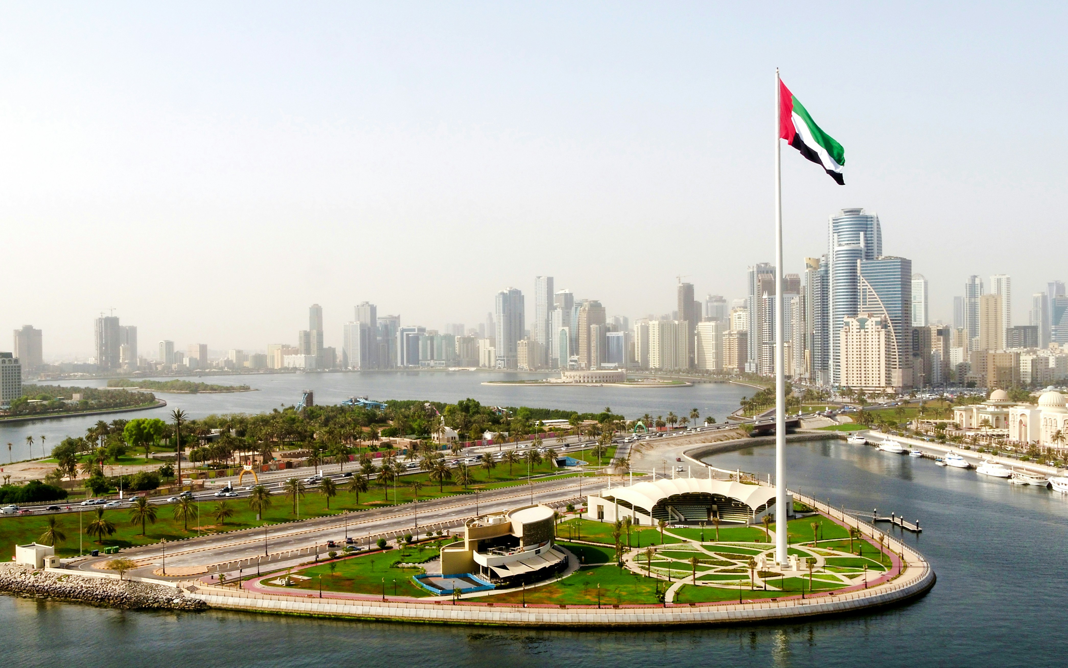 Flag Island with UAE flag and Sharjah skyline in the background.