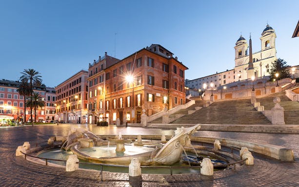 Spanish Steps and Fontana della Barcaccia illuminated at night, Rome.