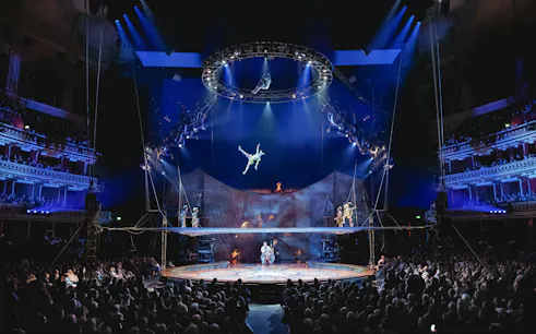 Acrobat performing mid-air at Cirque du Soleil: Kurios show in London.