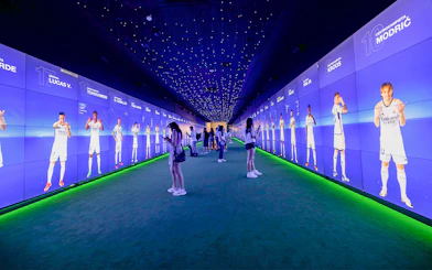 Visitors exploring digital displays at Santiago Bernabéu Stadium tour.