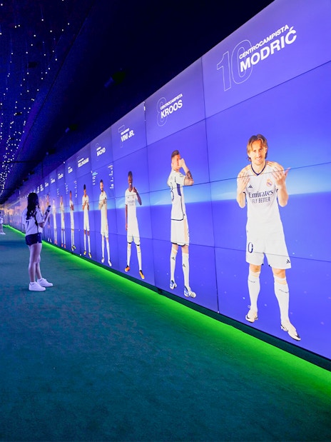 Visitors exploring digital displays at Santiago Bernabéu Stadium tour.