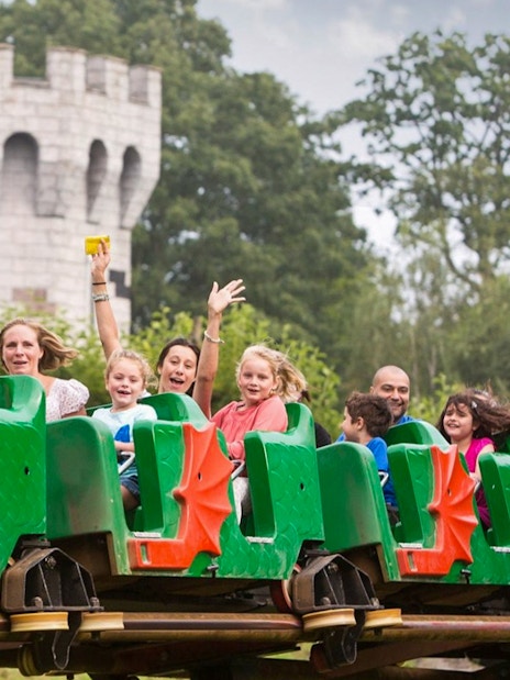 Visitors enjoying a dragon-themed roller coaster at LEGOLAND Windsor Resort.