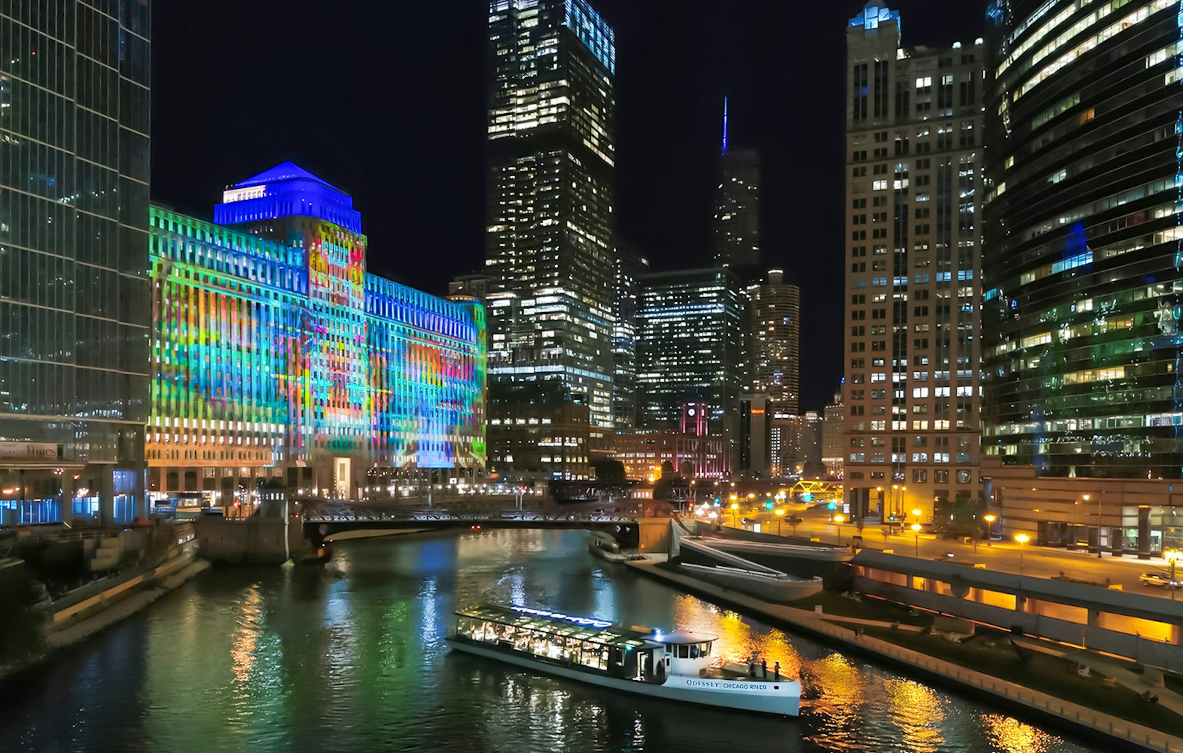 Dinner cruise boat on Chicago River with illuminated city skyline at night.