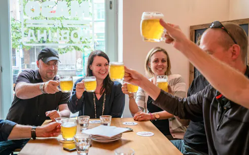Group enjoying beer mugs on a food and beer tour in Prague Old Town.