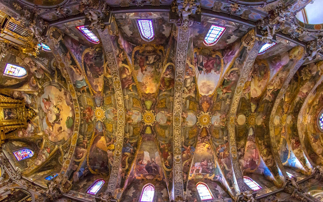 San Nicolas Church ceiling with intricate frescoes and stained glass windows, Valencia, Spain.