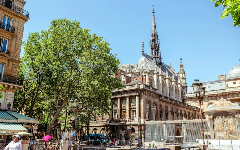Sainte-Chapelle exterior with spire and Gothic architecture on a sunny day in Paris.