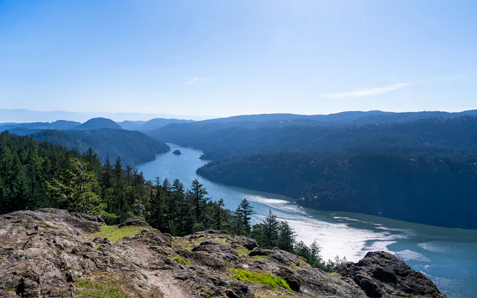 Saanich Inlet view with forested hills and winding waterway in British Columbia.