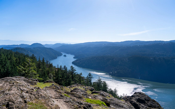 Saanich Inlet view with forested hills and winding waterway in British Columbia.