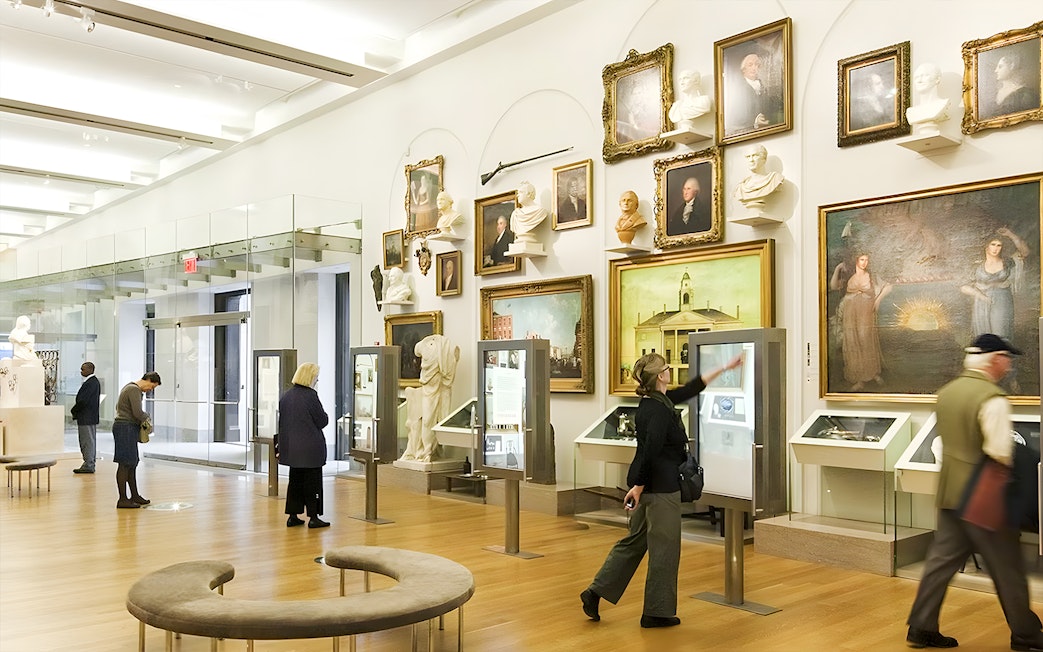 Visitors exploring exhibits at New York Historical Society.