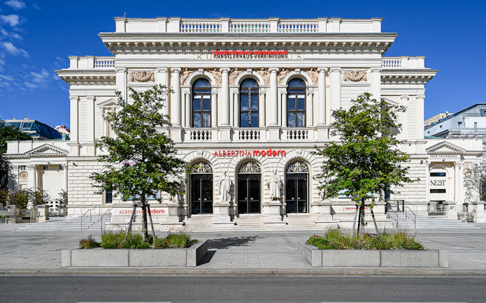 Exterior of ALBERTINA MODERN museum in Vienna with neoclassical architecture.