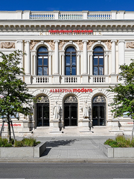 Exterior of ALBERTINA MODERN museum in Vienna with neoclassical architecture.