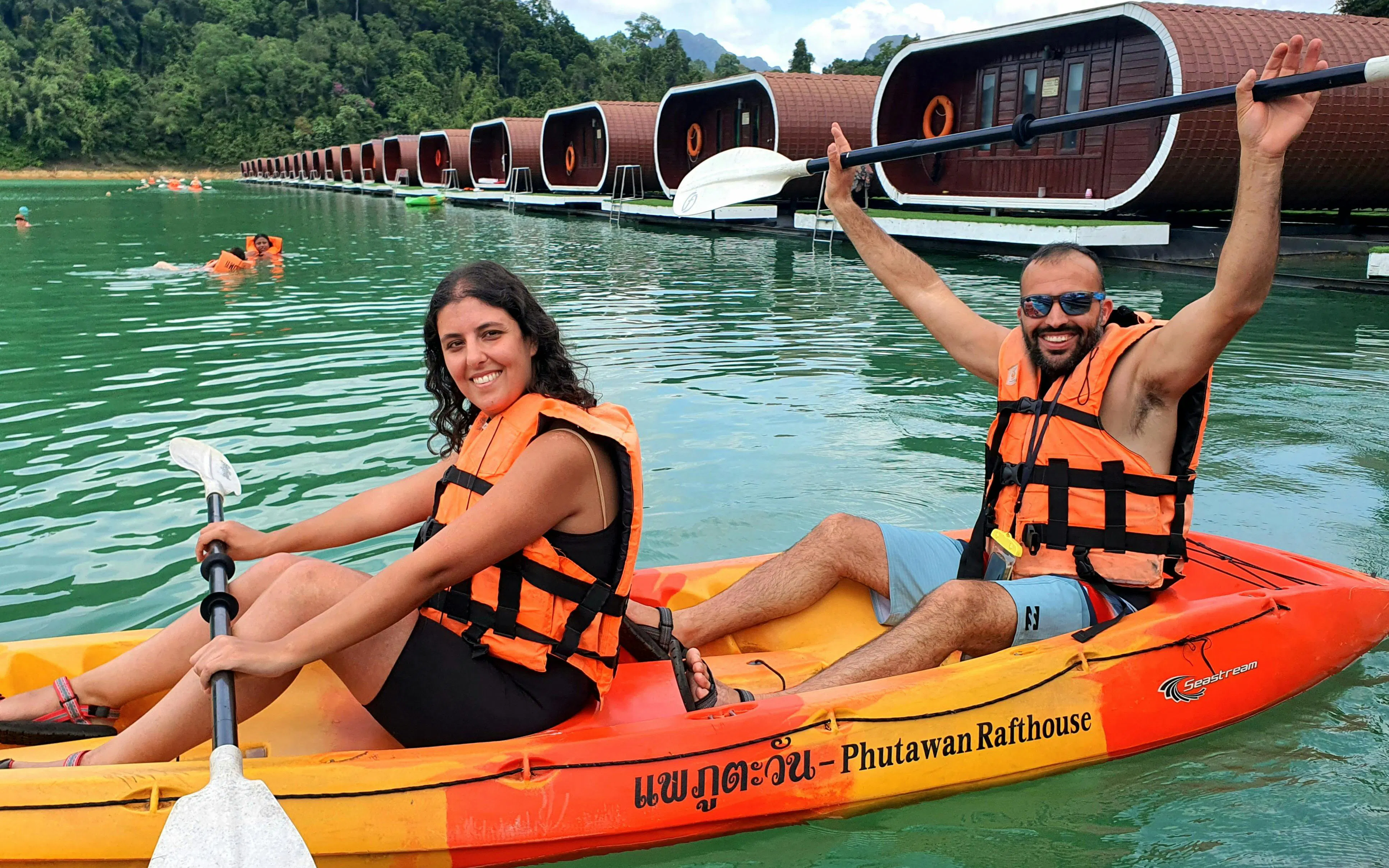 Kayakers on Cheow Lan Lake near floating bungalows, Krabi tour.