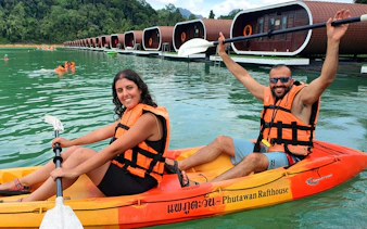 Kayakers on Cheow Lan Lake near floating bungalows, Krabi tour.