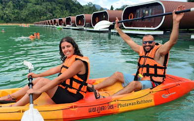 Kayakers on Cheow Lan Lake near floating bungalows, Krabi tour.