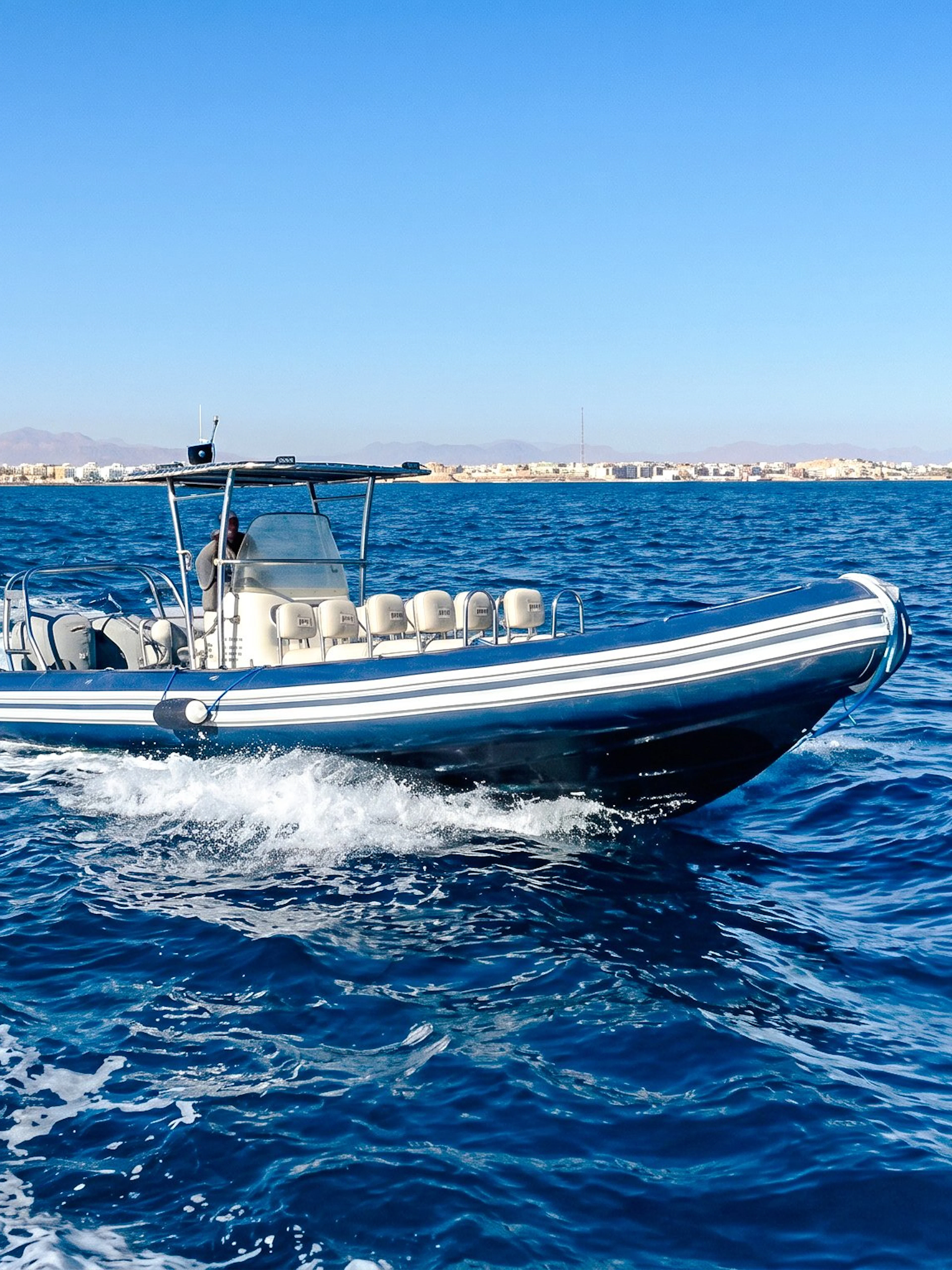 High-speed boat on sea during tour to Orange Bay or Magawish.