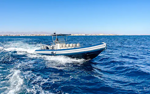 High-speed boat on sea during tour to Orange Bay or Magawish.