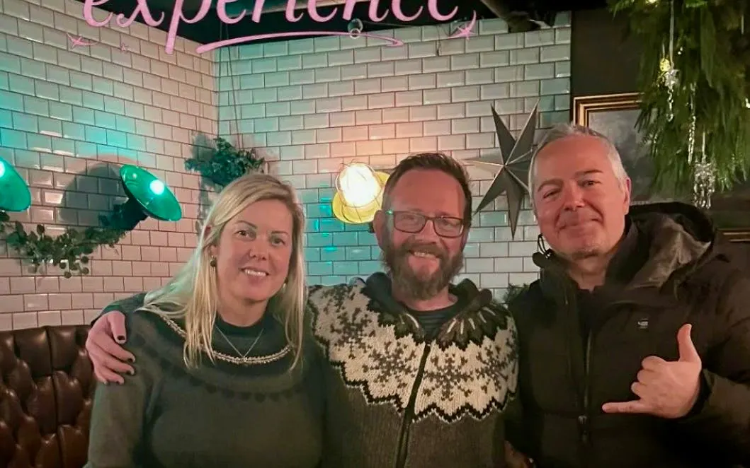 Three people enjoying a private Icelandic dining experience in an exclusive restaurant setting.