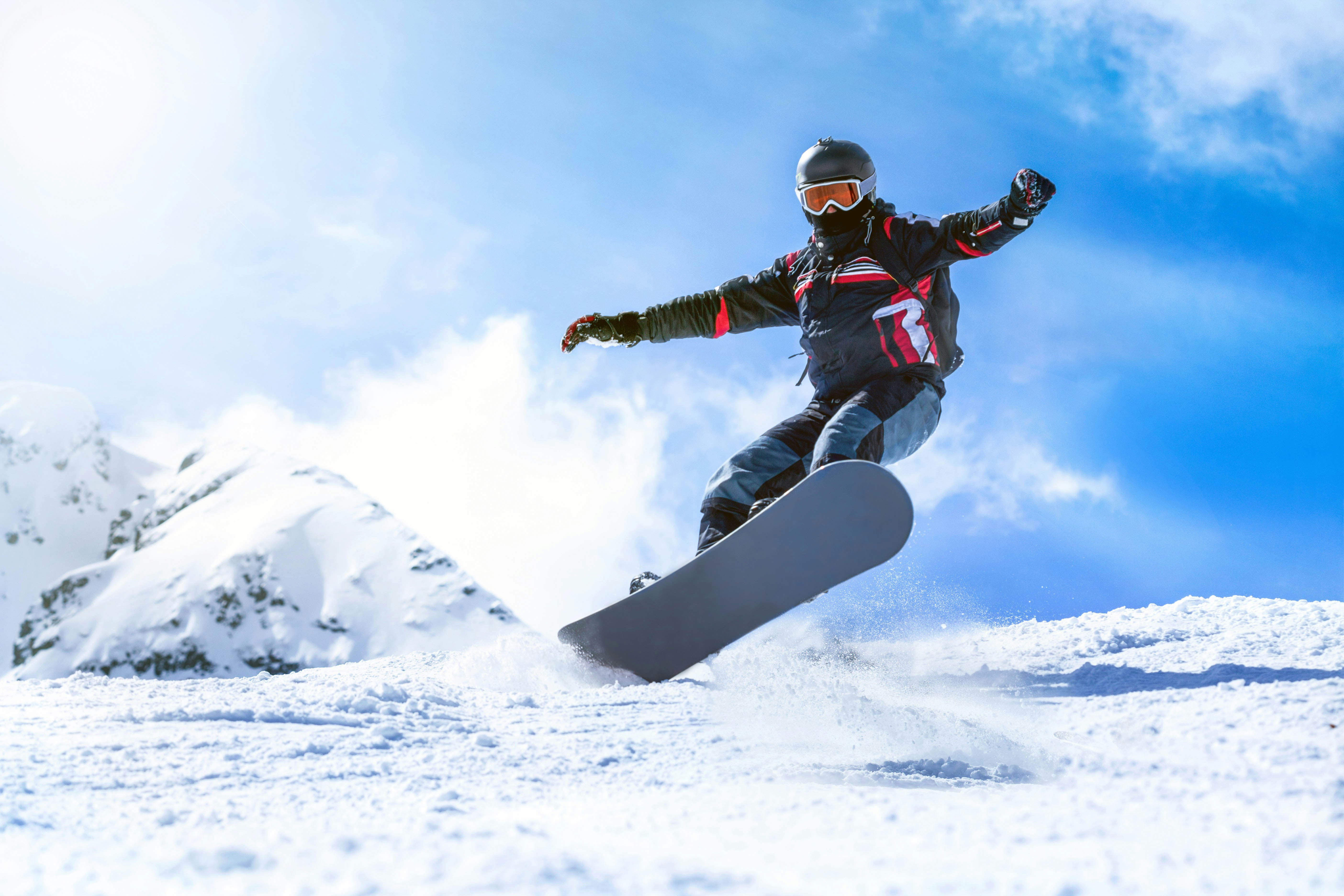 Snowboarder descending snowy slopes in Grindelwald, Switzerland with scenic mountain backdrop.