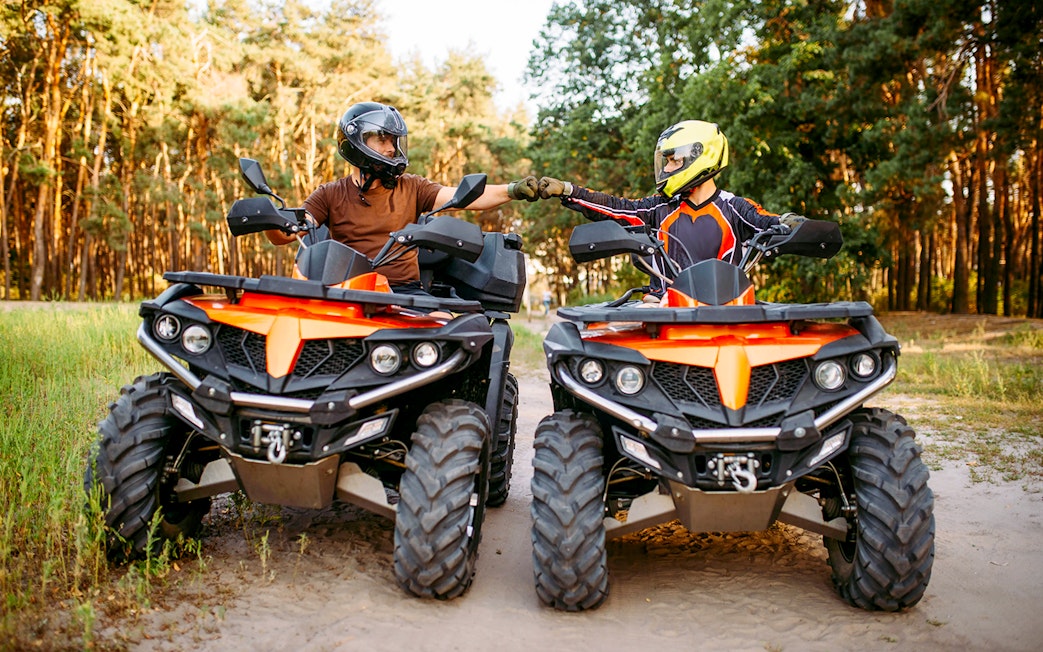 Guests on quad bikes in a forest during Zakopane adventure tour.