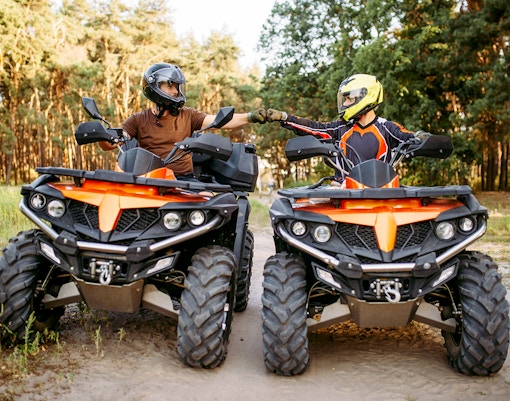 Guests on quad bikes in a forest during Zakopane adventure tour.