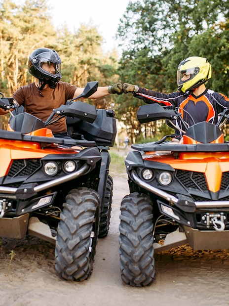 Guests on quad bikes in a forest during Zakopane adventure tour.