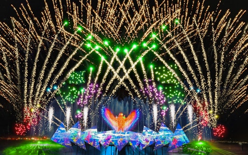 Fireworks display at Wings of Time show, Sentosa Island, with vibrant lights and water effects.