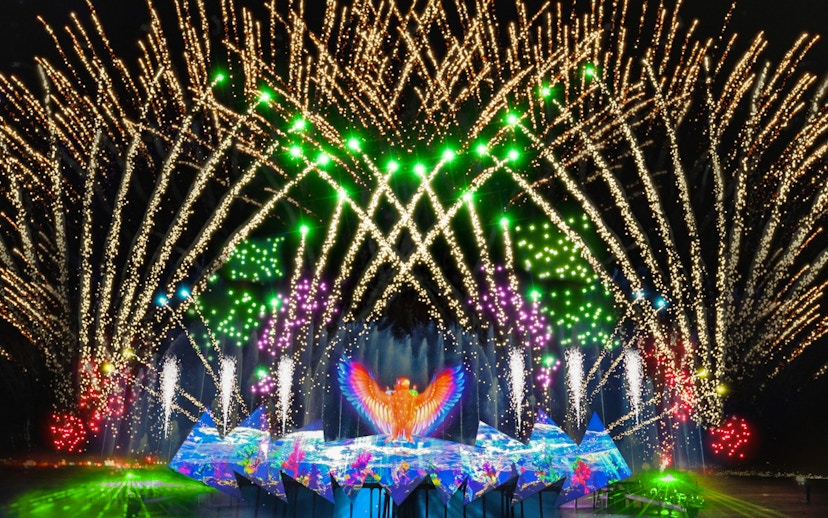Fireworks display at Wings of Time show, Sentosa Island, with vibrant lights and water effects.