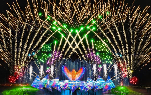 Fireworks display at Wings of Time show, Sentosa Island, with vibrant lights and water effects.