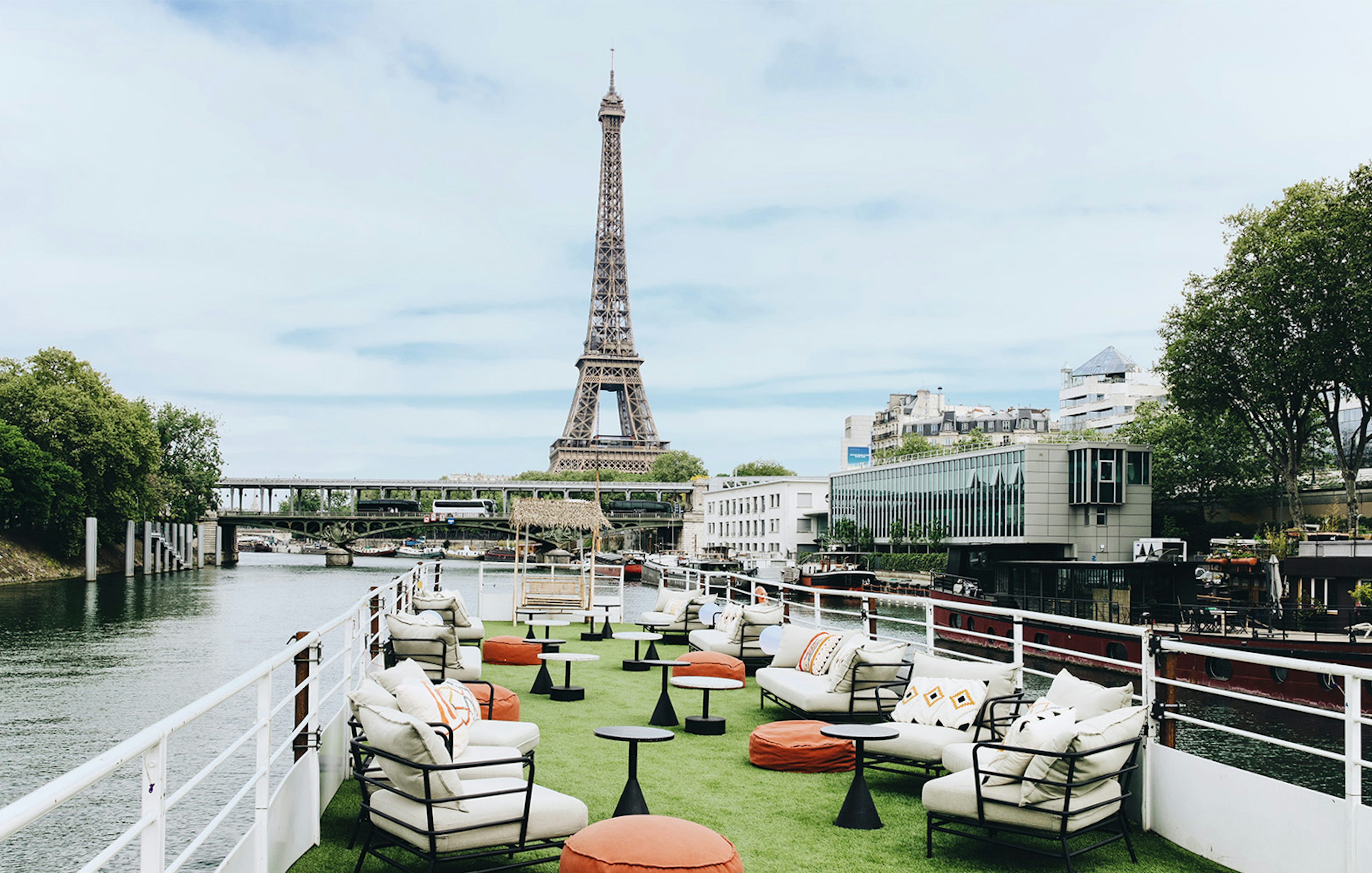 Rooftop seating on a boat cruise in Paris with Eiffel Tower view.