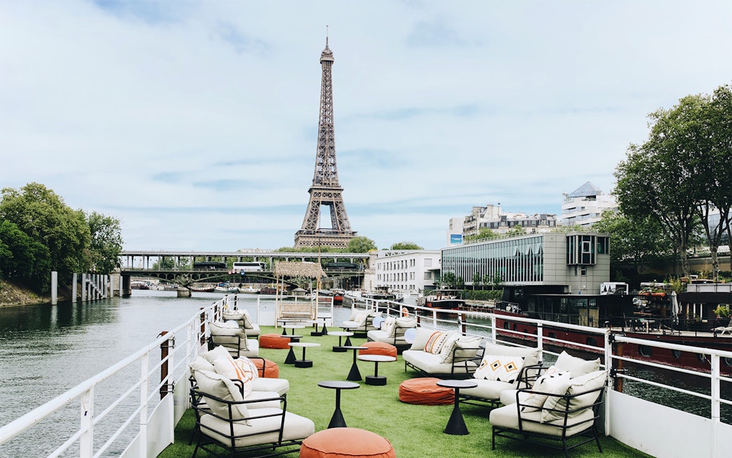 Rooftop seating on a boat cruise in Paris with Eiffel Tower view.