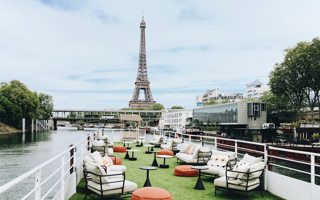 Rooftop seating on a boat cruise in Paris with Eiffel Tower view.