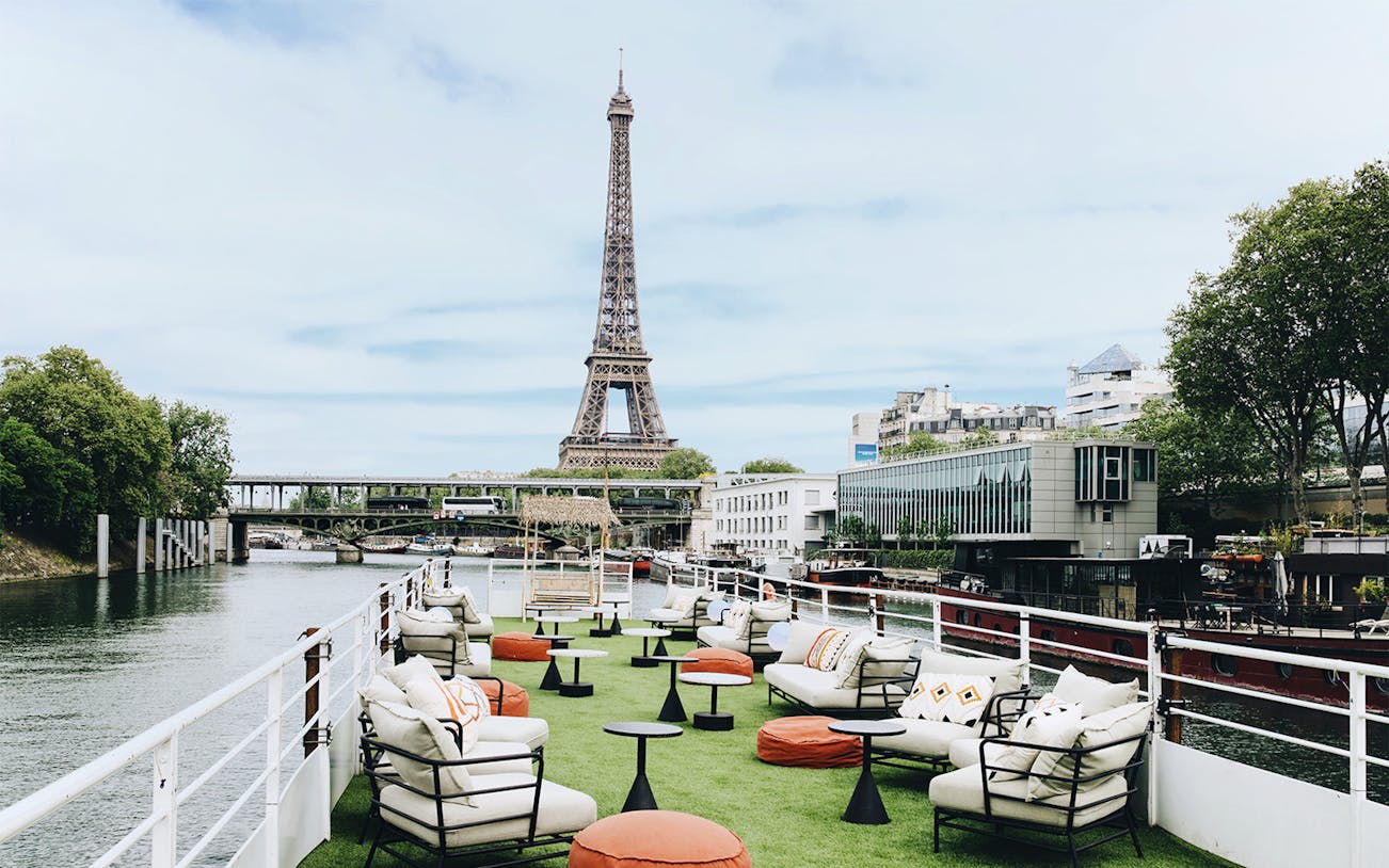 Rooftop seating on a boat cruise in Paris with Eiffel Tower view.