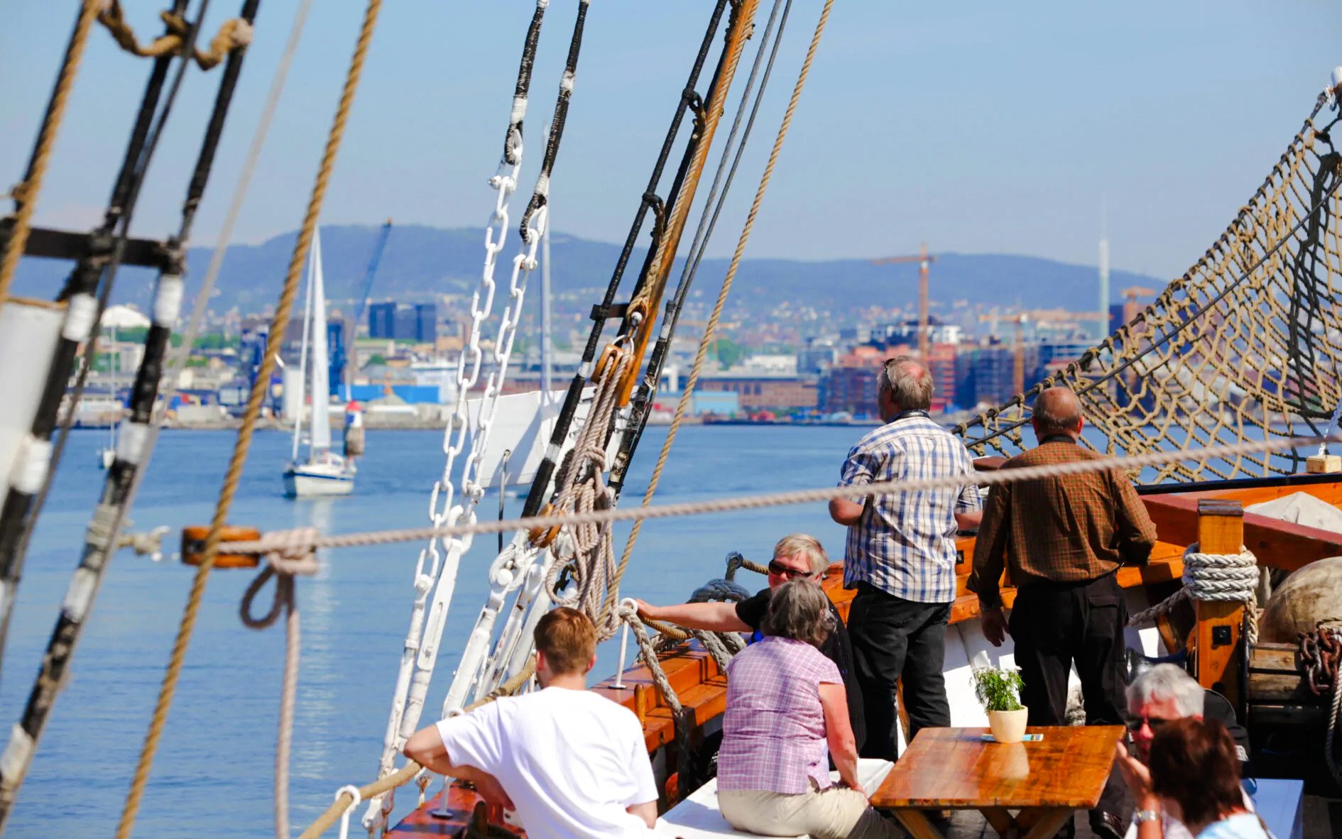 People enjoying a sailing ship fjord sightseeing cruise in Oslo.