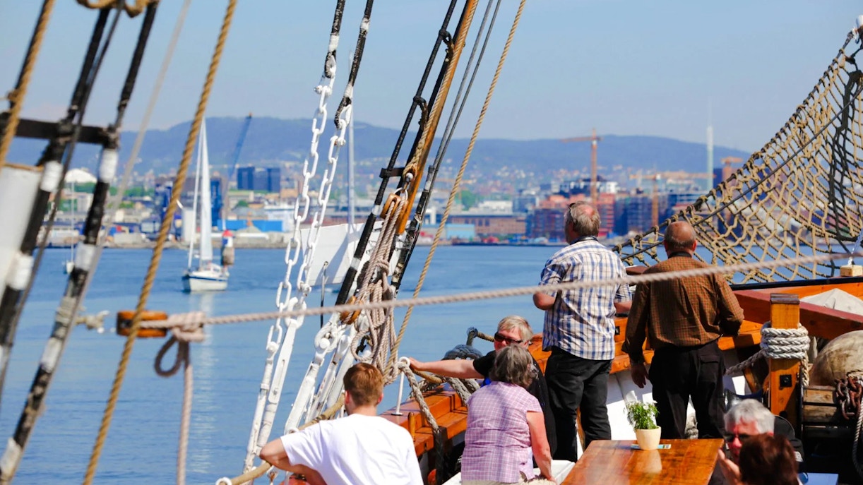 People enjoying a sailing ship fjord sightseeing cruise in Oslo.