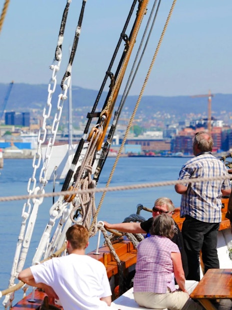 People enjoying a sailing ship fjord sightseeing cruise in Oslo.