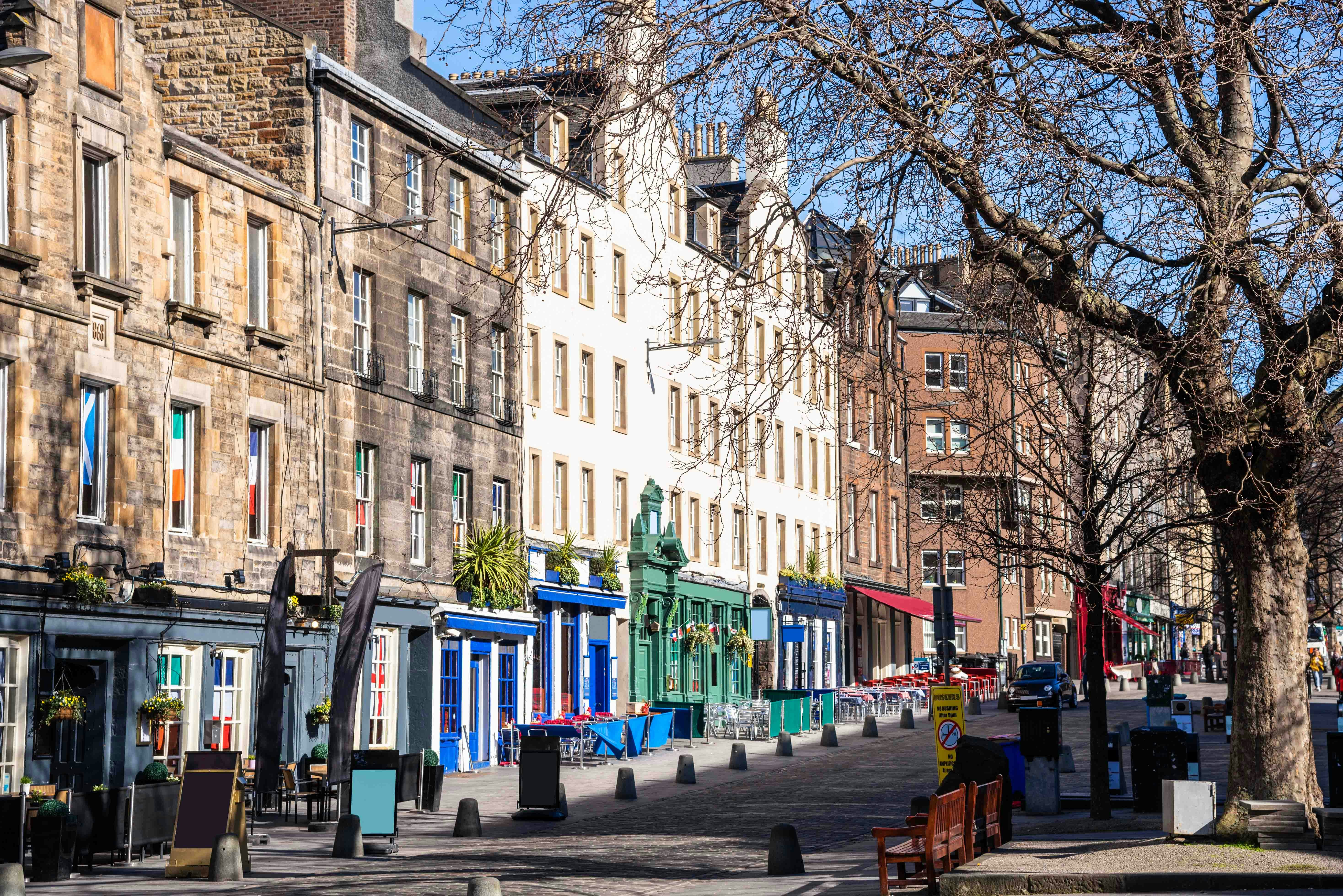Colorful historic buildings along Grassmarket street in Edinburgh.