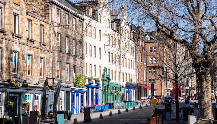 Grassmarket in Edinburgh with historic buildings and bustling street scene.