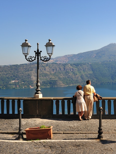 Tourist couple at Castel Gandolfo overlooking Lake Albano.