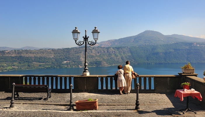 Tourist couple at Castel Gandolfo overlooking Lake Albano.