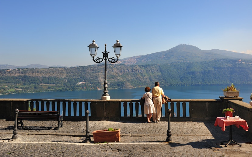Tourist couple at Castel Gandolfo overlooking Lake Albano.
