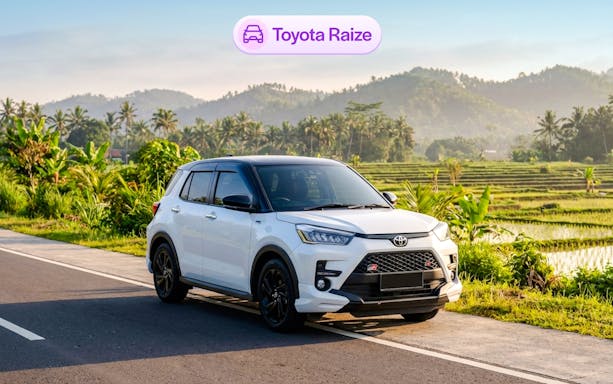 Toyota Raize parked on a road with Bali rice fields in the background.