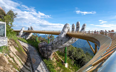 Golden Bridge held by giant hands at Sun World Ba Na Hills, Vietnam.